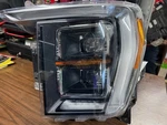 21-23 Ford F-150LH Headlamp Assy ML34-13E017-DA Missing Tab. Fixed Price $500.00.